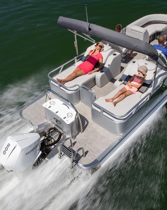 Family lounging on pontoon with adjustable cover